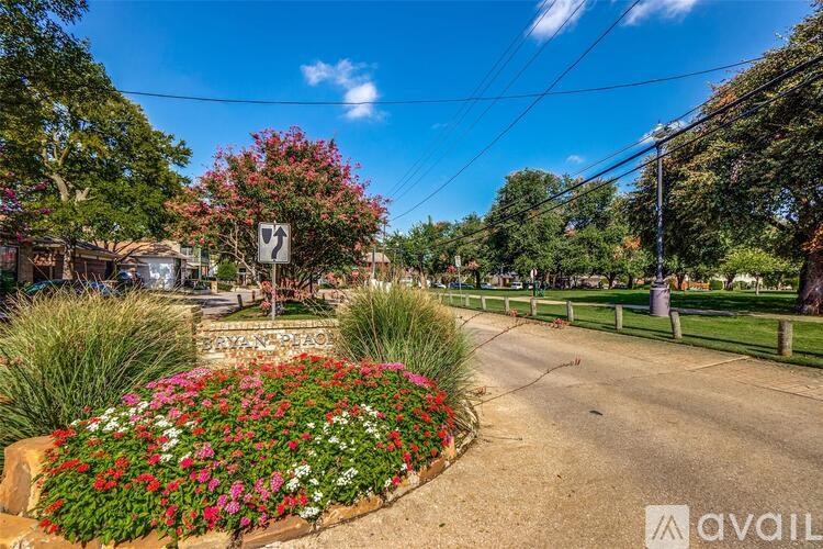 A street view with a sign that says "Avila" and a flower bed in the foreground.