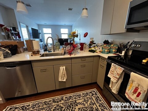 A kitchen with a lot of counter space and a dishwasher.