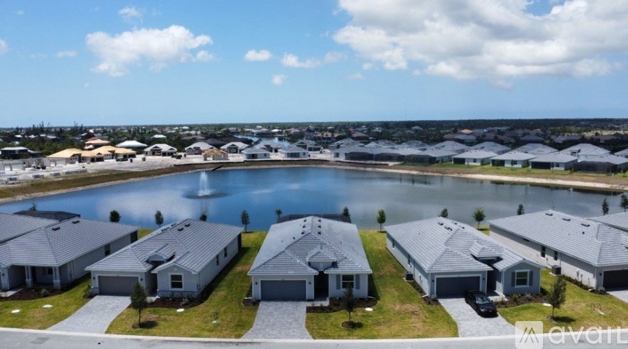 A row of houses with a body of water in front of them.