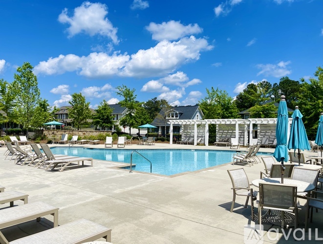 A pool area with chairs and umbrellas is available for use.
