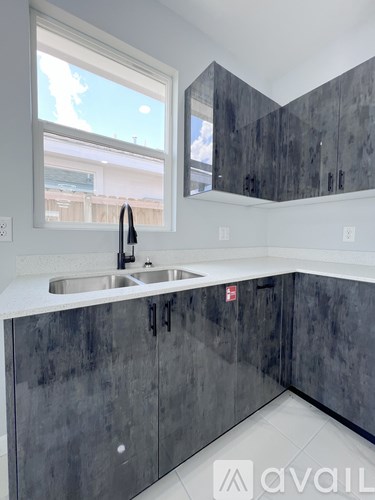 A kitchen with a sink and cabinets.