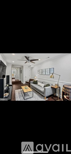 A living room with a grey sofa and a coffee table.
