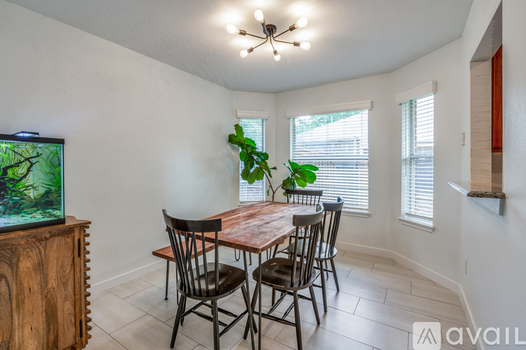 A dining room with a wooden table and chairs.