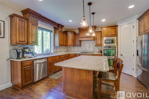 A kitchen with wooden cabinets and a granite countertop.