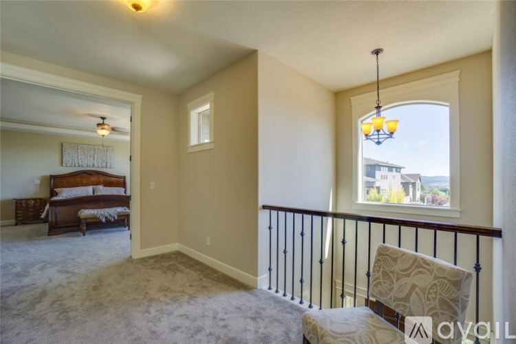 A bedroom with a bed and a chair in it.