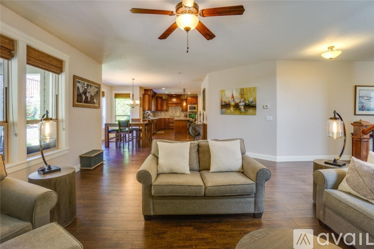 A living room with a couch, a chair, and a table.