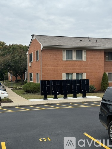 A parking lot with a car and a building in the background.