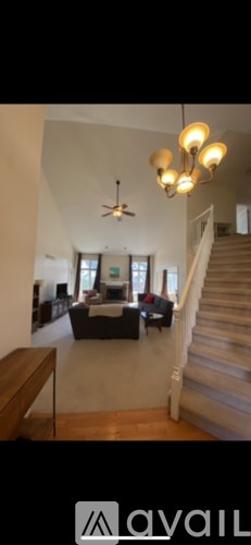 A living room with a couch and a ceiling fan.