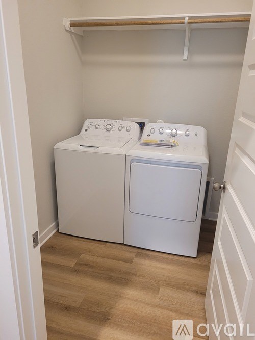 A small laundry room with a washer and dryer.