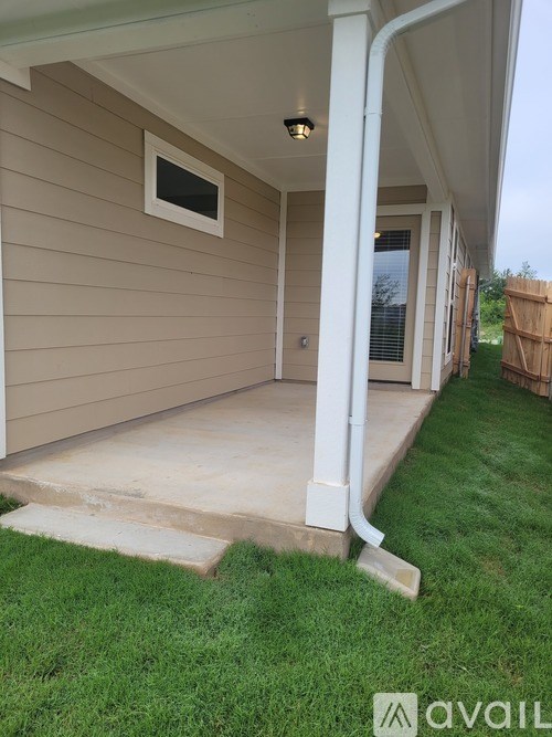 A house with a white pillar and a window.