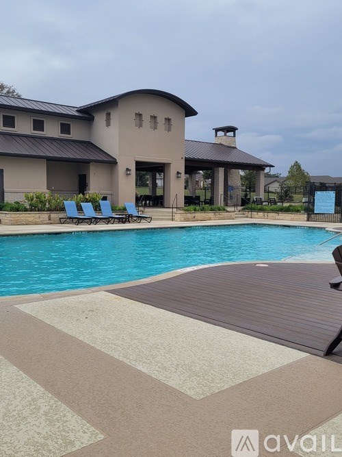 A pool with a house in the background.