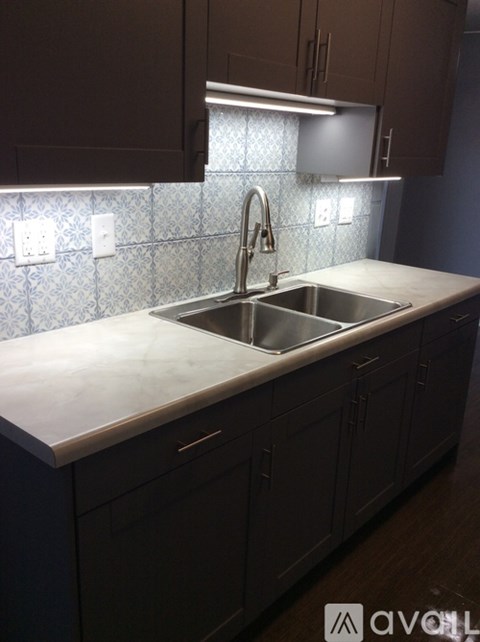 A kitchen with a sink and cabinets.