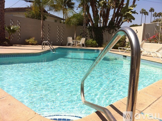 A swimming pool with a metal ladder in the foreground.