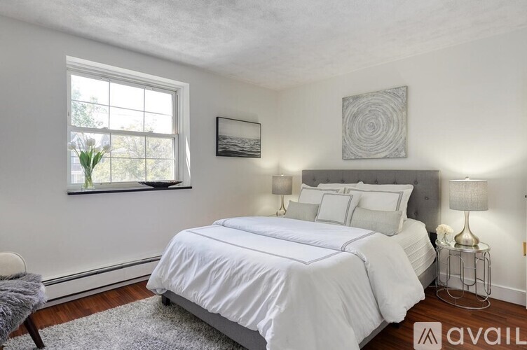 A bedroom with a large bed and a window.