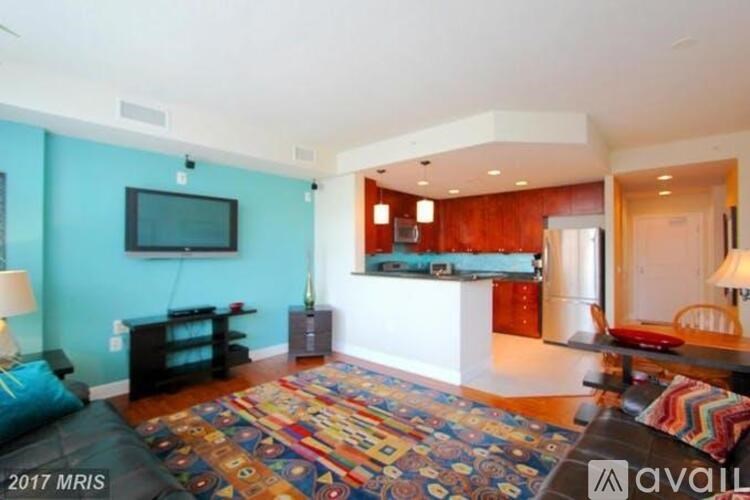 A living room with a blue wall and a television.