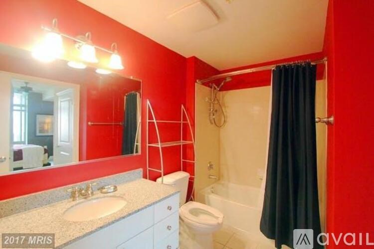 A bathroom with red walls and a white toilet.