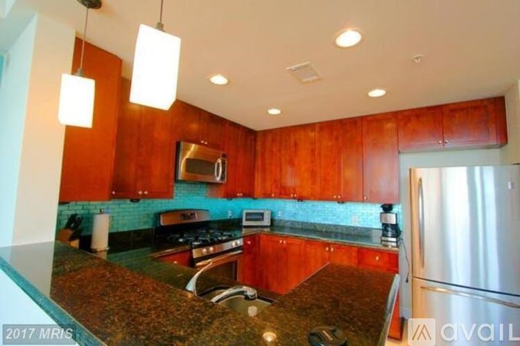 A kitchen with wooden cabinets and a granite countertop.