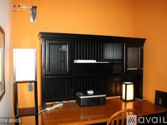 A black cabinet with a television on top of it.