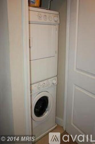 A white oven and washing machine in a kitchen.