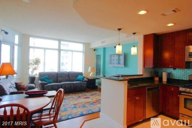 A kitchen with a dining table and chairs in front of a window.
