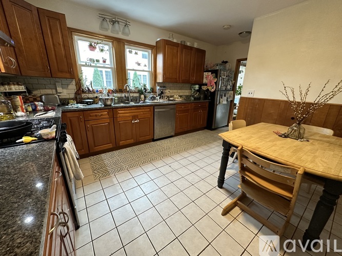 A kitchen with wooden cabinets and a black stove top oven.