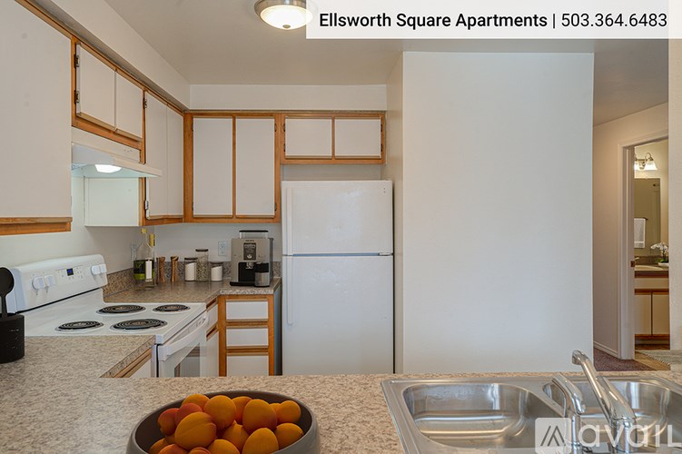 A kitchen with a bowl of oranges on the counter.
