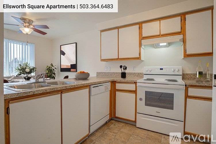 A kitchen with white appliances and wooden cabinets.