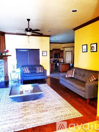A living room with a grey couch and a coffee table.