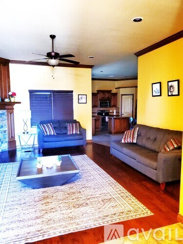 A living room with a grey couch and a coffee table.