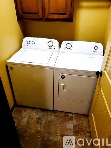 Two washing machines in a small room.