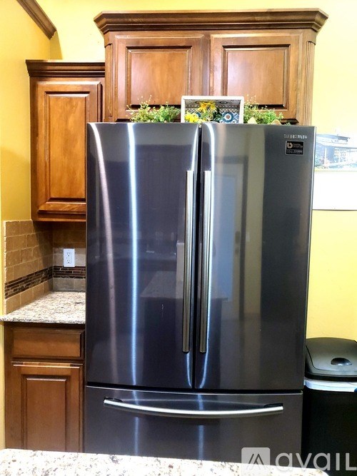 A stainless steel refrigerator with a magnet on the door.