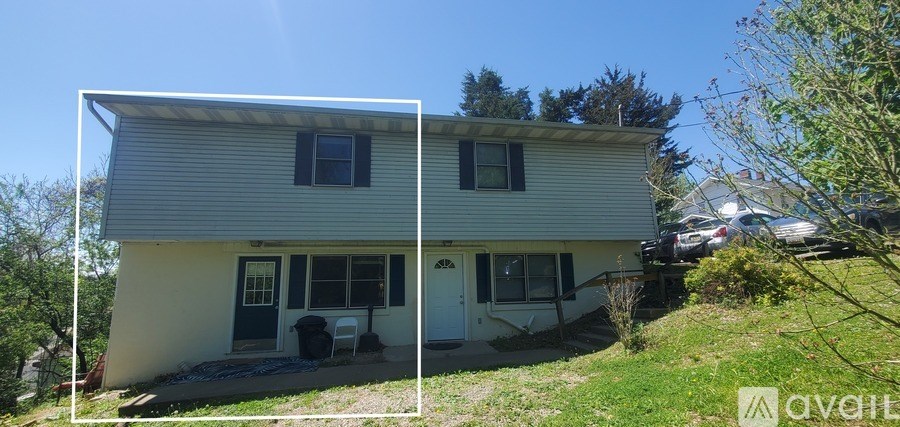 A house with a car parked in front of it.
