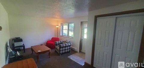 A living room with a couch, chair, and coffee table.