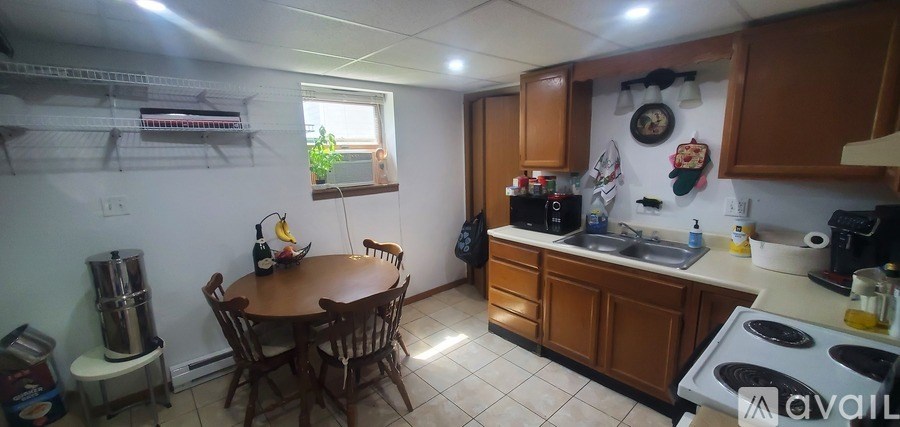 A kitchen with a table and chairs in the middle of the room.