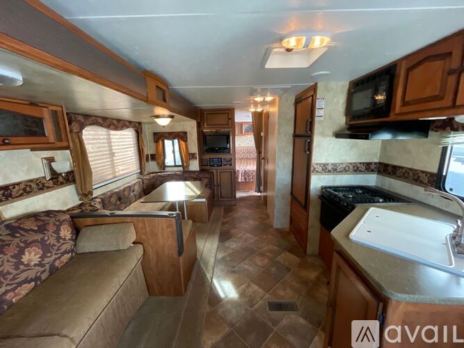 A kitchen area with a sink, microwave, and oven.