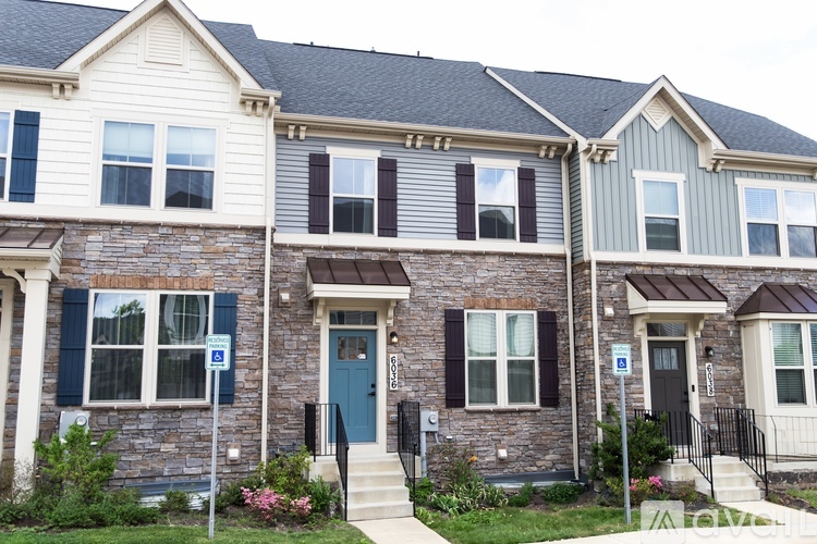A row of houses with a blue sign on the front door.