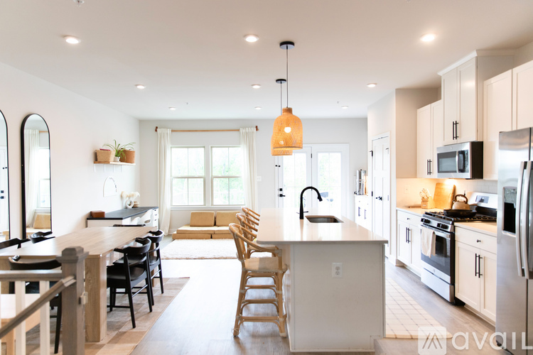 A kitchen with a table and chairs in the middle of the room.
