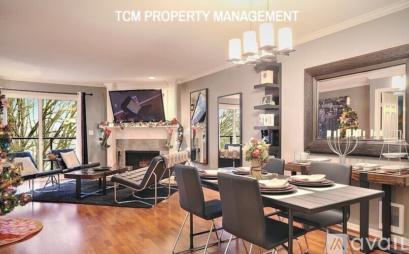 A living room with a fireplace and a dining table set for a meal.