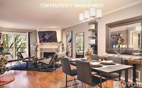 A living room with a fireplace and a dining table set for a meal.