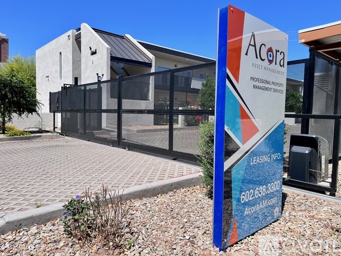 A sign for Acora Asset Management in front of a building.