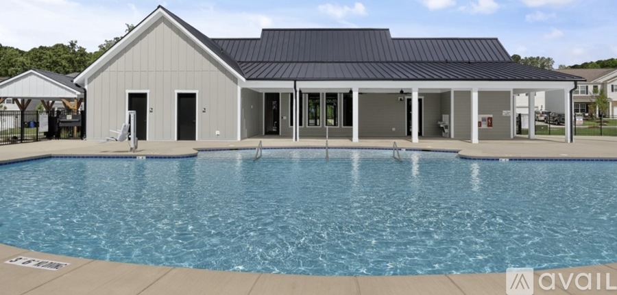 A pool in front of a building with a sign that says "available".