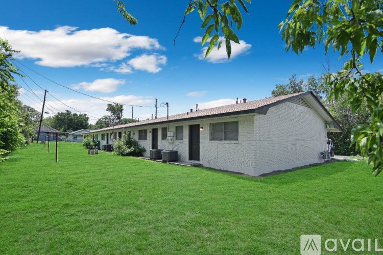 A bathroom with a sink, toilet, and mirror.