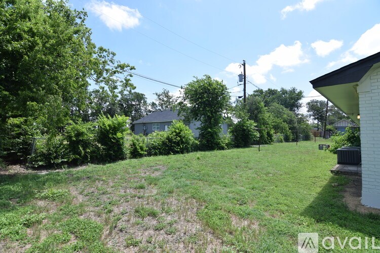 A room with a brown door and a window with white blinds.