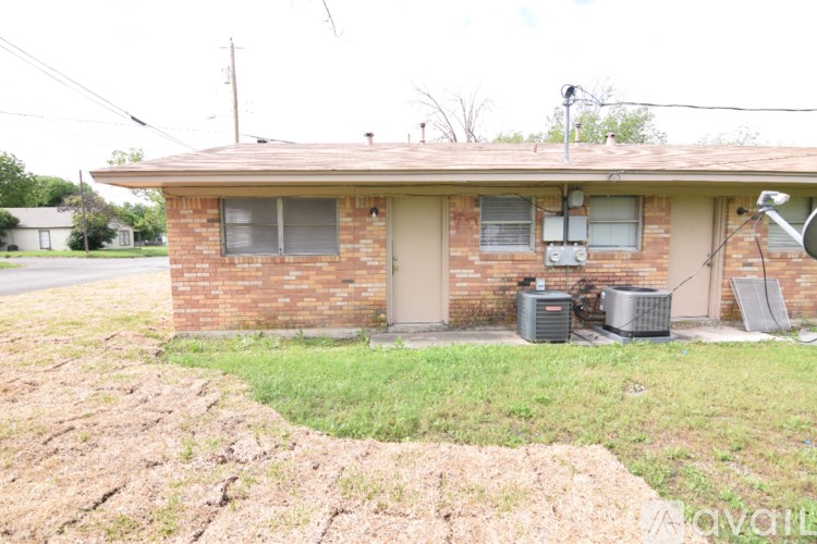 A house with a brown brick exterior and a white door.
