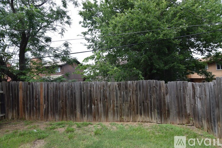 A kitchen with white appliances and cabinets.
