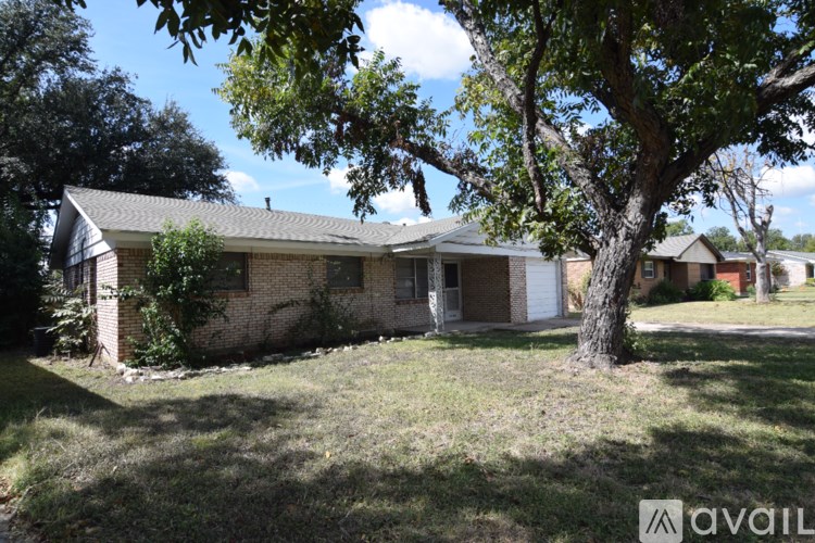 A house with a tree in front of it is for sale.