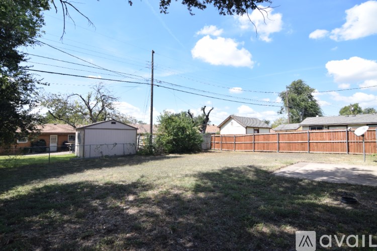 A sunny day in a residential area with houses and trees.