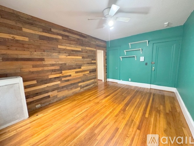 A room with wooden floors and a wall made of wooden planks.