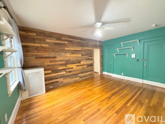 A room with wooden walls and a ceiling fan.