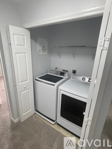 A small kitchen with a white oven and microwave.